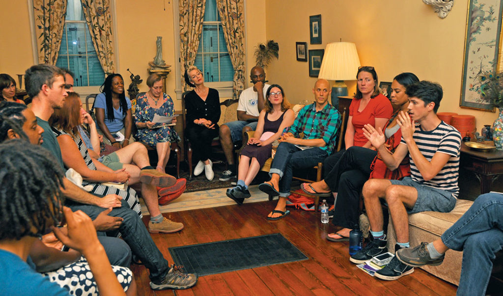members seated around the living room in discussion