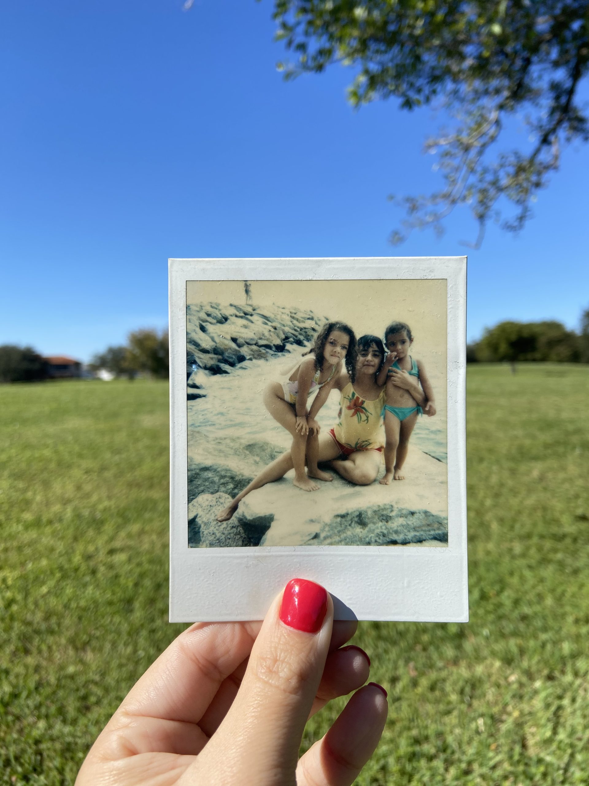 Polaroid of Erika Marcano with her sister and mom at the beach in Venezuela